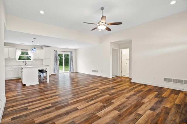 5111 Democracy Dr, Ashland, MO 65010 - unfurnished living room featuring dark wood-type flooring, a ceiling fan, recessed lighting, baseboards, and a sink