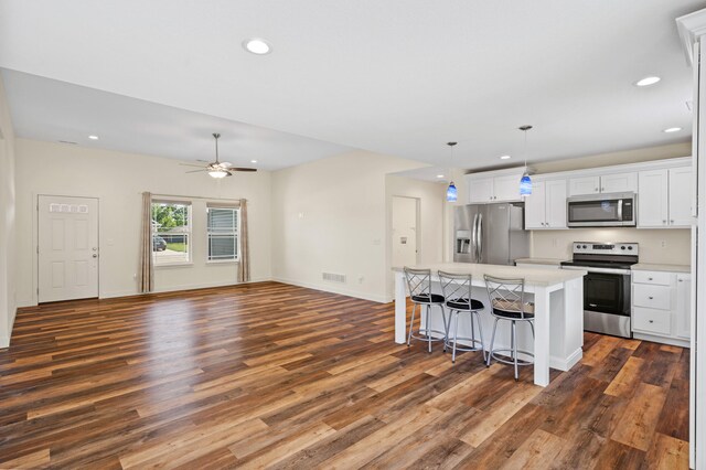 5111 Democracy Dr, Ashland, MO 65010 - kitchen featuring stainless steel appliances, dark wood-style flooring, a center island, recessed lighting, and a kitchen breakfast bar