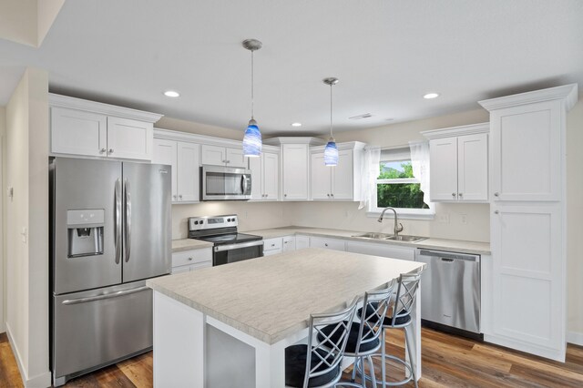 5111 Democracy Dr, Ashland, MO 65010 - kitchen with stainless steel appliances, a sink, white cabinets, dark wood-type flooring, and recessed lighting