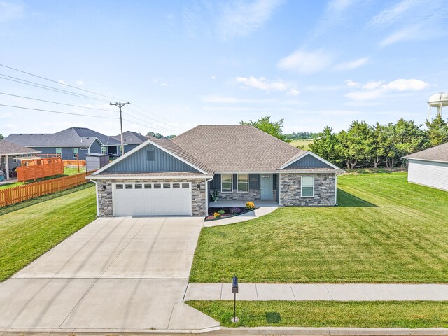 5111 Democracy Dr, Ashland, MO 65010 - view of front facade with stone siding, driveway, a garage, and board and batten siding