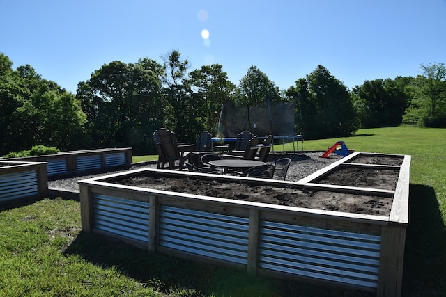 5100 E Dunbar Ln, Centralia, MO 65240 - view of grassy yard featuring a trampoline and a garden