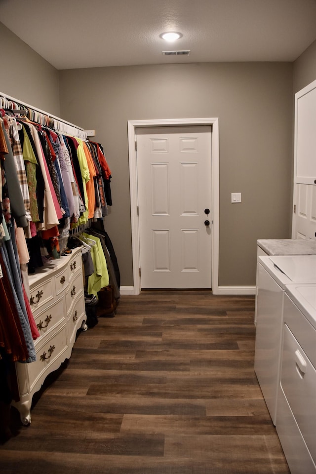 5100 E Dunbar Ln, Centralia, MO 65240 - washroom featuring washing machine and dryer, dark wood-style floors, and baseboards