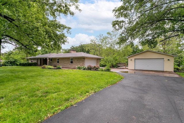 1804 N Pin Oak Blvd, Columbia, MO 65202 - view of home's exterior with a detached garage, a chimney, a yard, brick siding, and an outbuilding