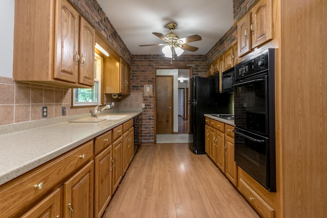 1804 N Pin Oak Blvd, Columbia, MO 65202 - kitchen with black appliances, ceiling fan, a sink, light wood-type flooring, and light countertops