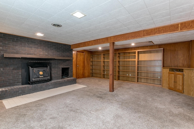 1804 N Pin Oak Blvd, Columbia, MO 65202 - unfurnished living room featuring carpet, a fireplace, and wooden walls