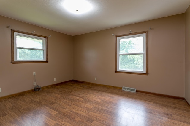 1804 N Pin Oak Blvd, Columbia, MO 65202 - empty room featuring wood finished floors, healthy amount of natural light, and baseboards