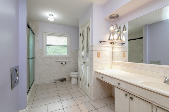 1804 N Pin Oak Blvd, Columbia, MO 65202 - full bath with tile patterned floors, a closet, tile walls, toilet, and vanity