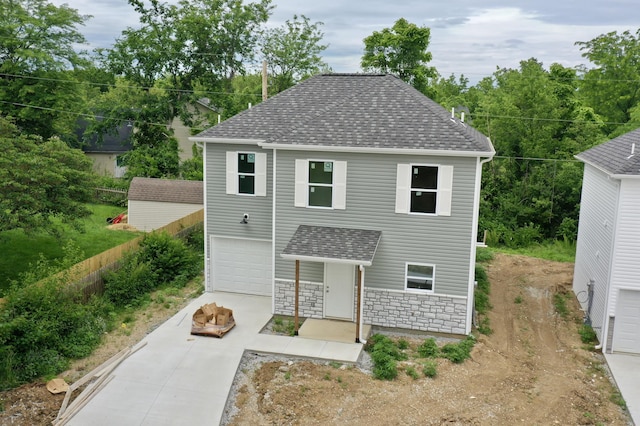 2501 Nest Ct, Columbia, MO 65202 - view of front of property with concrete driveway, a shingled roof, an outdoor fire pit, and stone siding