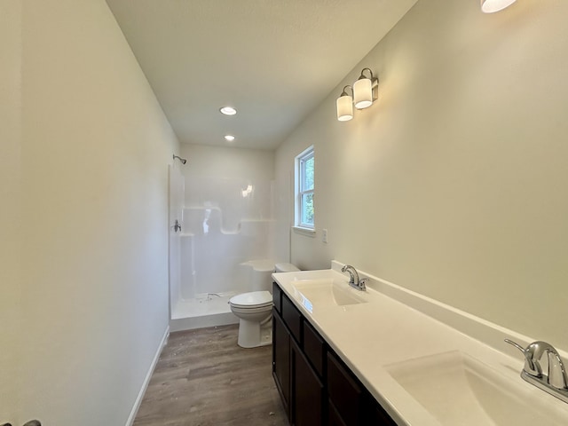2501 Nest Ct, Columbia, MO 65202 - full bathroom featuring a stall shower, wood finished floors, toilet, baseboards, and double vanity