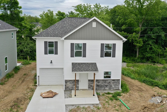 2505 Nest Ct, Columbia, MO 65202 - view of front facade featuring concrete driveway, a shingled roof, a garage, board and batten siding, and stone siding