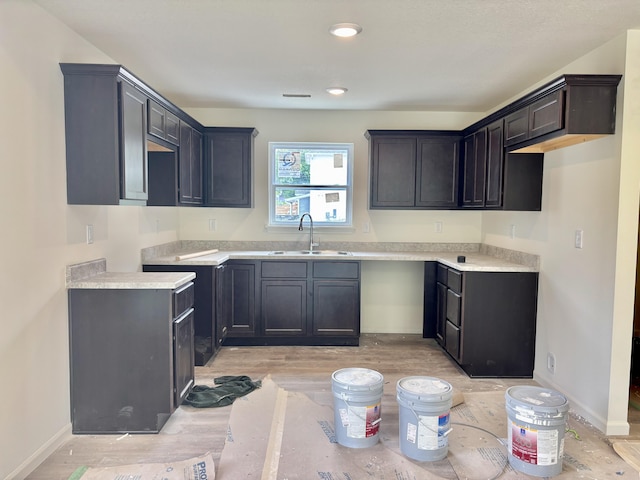 2505 Nest Ct, Columbia, MO 65202 - kitchen with a sink, light wood-style floors, and baseboards