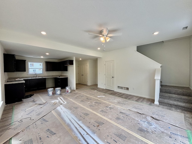 2505 Nest Ct, Columbia, MO 65202 - unfurnished living room with ceiling fan, stairs, recessed lighting, a sink, and baseboards
