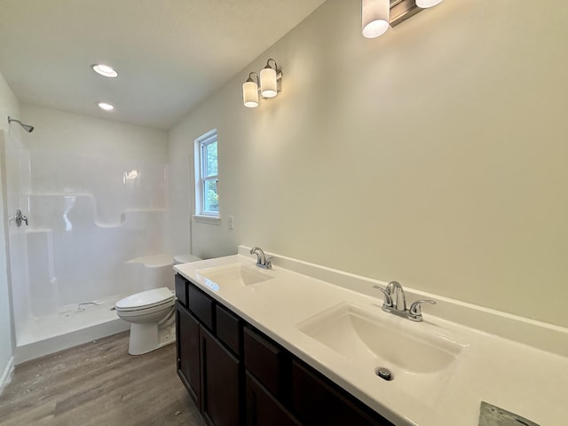 2505 Nest Ct, Columbia, MO 65202 - bathroom with wood finished floors, a shower, toilet, double vanity, and recessed lighting