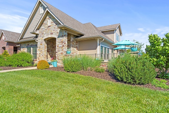 1732 Linkside Dr, Columbia, MO 65201 - craftsman-style house featuring stone siding, a front yard, and a shingled roof