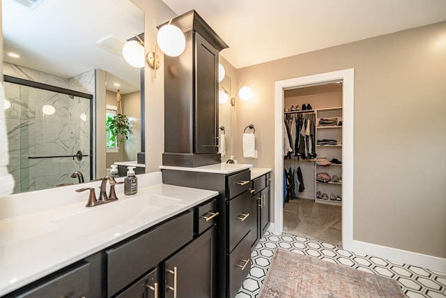 1043 Shore Acres, Columbia, MO 65201 - bathroom with vanity, a stall shower, a spacious closet, baseboards, and tile patterned flooring