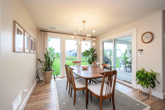 1043 Shore Acres, Columbia, MO 65201 - dining space featuring plenty of natural light, light wood-type flooring, a chandelier, and baseboards