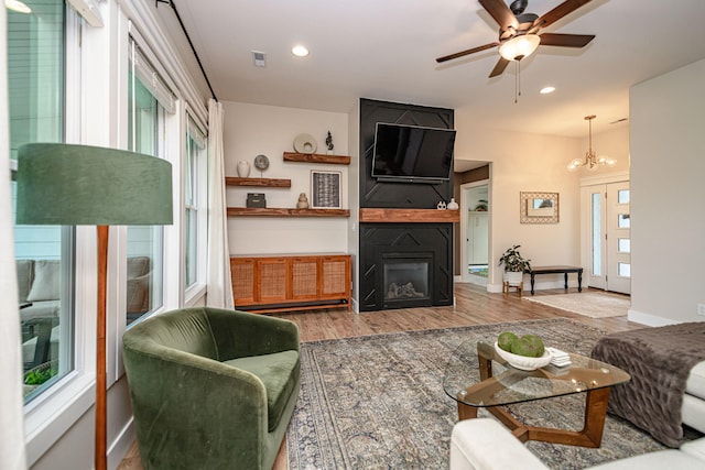 1043 Shore Acres, Columbia, MO 65201 - living area featuring a large fireplace, a ceiling fan, wood finished floors, a chandelier, and recessed lighting