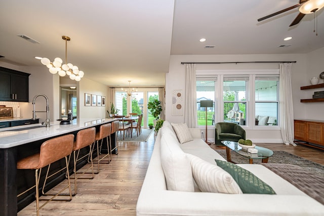 1043 Shore Acres, Columbia, MO 65201 - living room featuring light wood-type flooring, ceiling fan, a chandelier, and recessed lighting