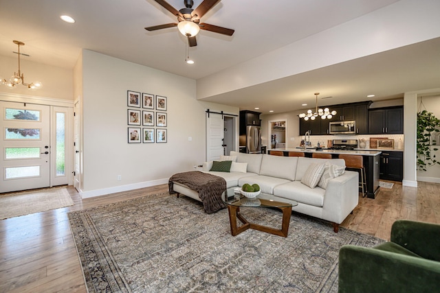 1043 Shore Acres, Columbia, MO 65201 - living area with a chandelier, a barn door, light wood finished floors, baseboards, and recessed lighting