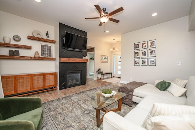 1043 Shore Acres, Columbia, MO 65201 - living room with wood finished floors, recessed lighting, ceiling fan, a large fireplace, and a chandelier