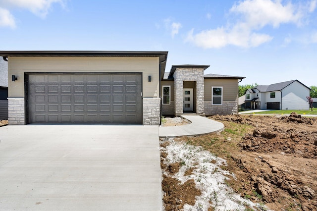 404 Sugarberry Dr, Columbia, MO 65201 - modern home with stone siding, driveway, and an attached garage