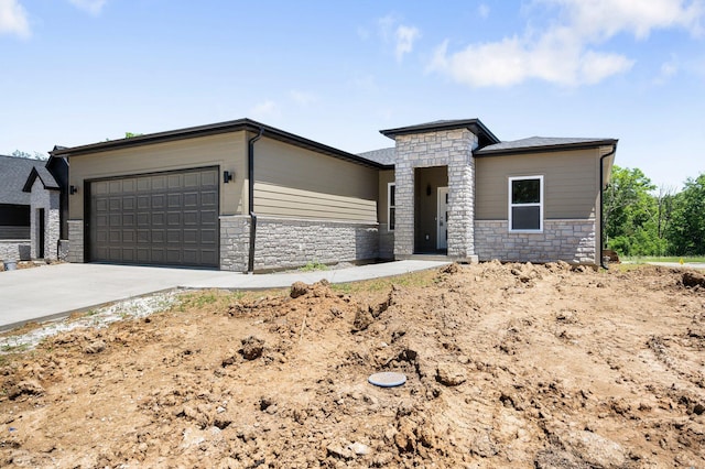 404 Sugarberry Dr, Columbia, MO 65201 - view of front facade with stone siding, a garage, and driveway