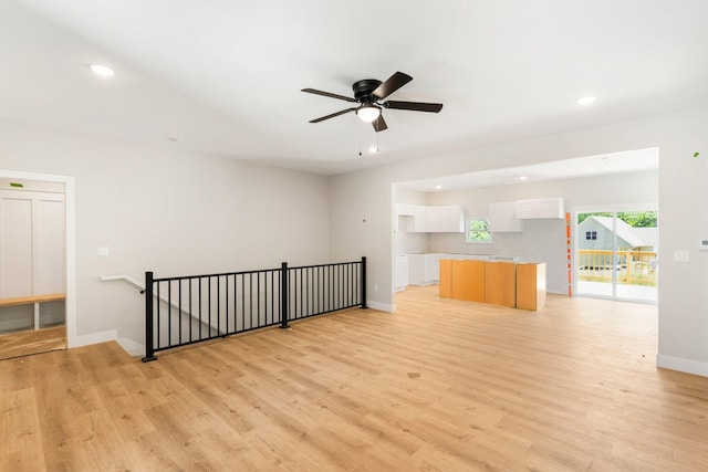 404 Sugarberry Dr, Columbia, MO 65201 - unfurnished living room with light wood-style floors, recessed lighting, a ceiling fan, and baseboards