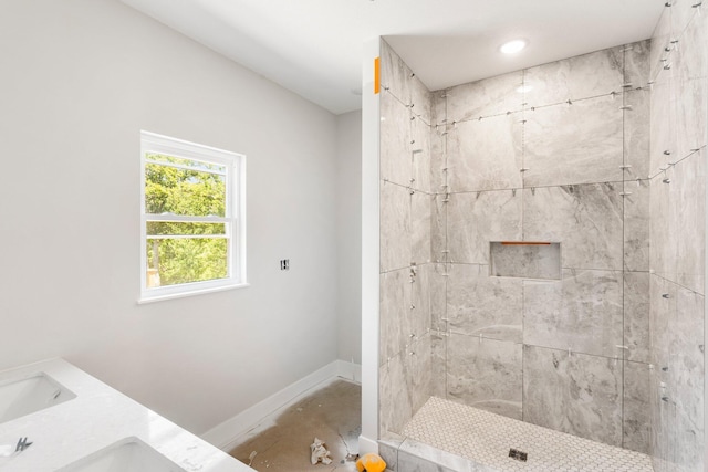 404 Sugarberry Dr, Columbia, MO 65201 - bathroom featuring baseboards, tiled shower, and double vanity