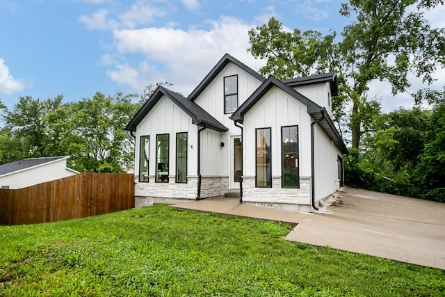 210 Hickam Aly, Ashland, MO 65010 - back of property featuring board and batten siding, stone siding, and a patio area