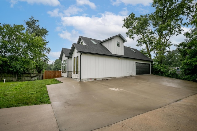 210 Hickam Aly, Ashland, MO 65010 - view of side of home with driveway, a shingled roof, board and batten siding, and an attached garage