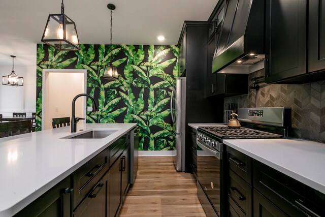 210 Hickam Aly, Ashland, MO 65010 - kitchen with appliances with stainless steel finishes, ventilation hood, light countertops, decorative light fixtures, and wallpapered walls