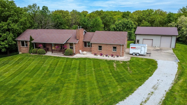 1820 N Hemlock Ridge Rd, Rocheport, MO 65279 - ranch-style home with a porch, a detached garage, a front yard, and brick siding