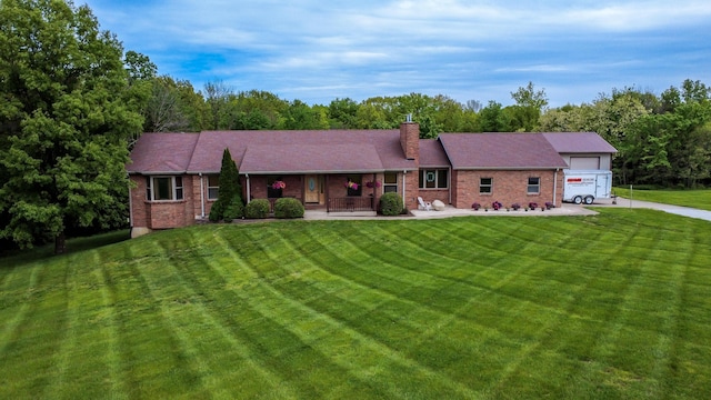 1820 N Hemlock Ridge Rd, Rocheport, MO 65279 - ranch-style home featuring driveway, a front yard, covered porch, brick siding, and a chimney