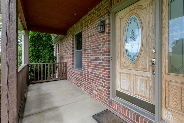 1820 N Hemlock Ridge Rd, Rocheport, MO 65279 - view of exterior entry featuring a porch and brick siding