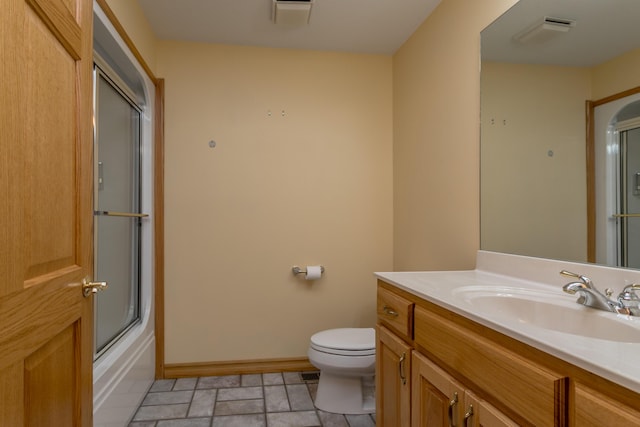 1820 N Hemlock Ridge Rd, Rocheport, MO 65279 - bathroom with vanity, toilet, baseboards, stone finish floors, and combined bath / shower with glass door