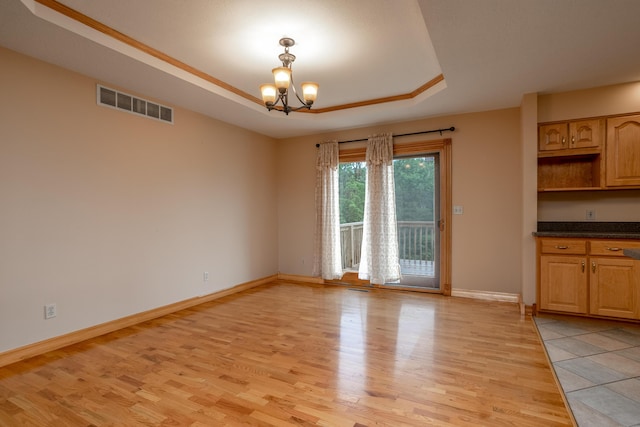 1820 N Hemlock Ridge Rd, Rocheport, MO 65279 - unfurnished dining area featuring a chandelier, light wood-type flooring, a tray ceiling, and baseboards