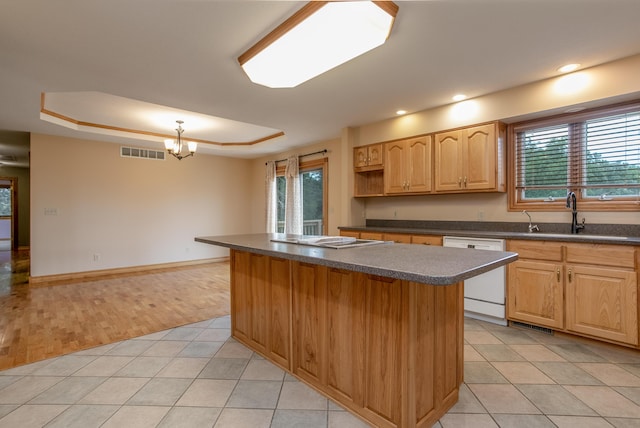 1820 N Hemlock Ridge Rd, Rocheport, MO 65279 - kitchen featuring white dishwasher, dark countertops, a center island, stovetop with downdraft, and a sink