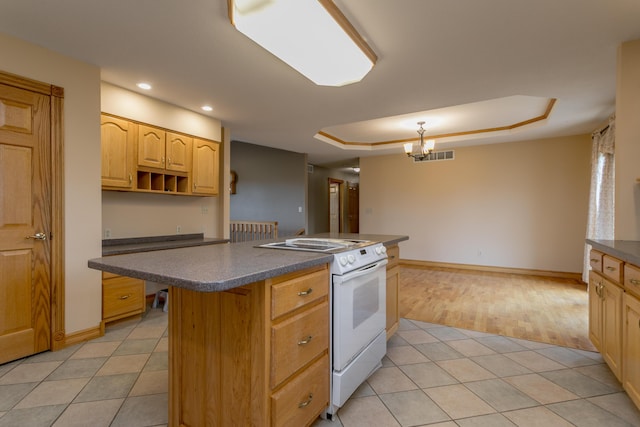 1820 N Hemlock Ridge Rd, Rocheport, MO 65279 - kitchen with electric range, dark countertops, a raised ceiling, light tile patterned flooring, and a center island