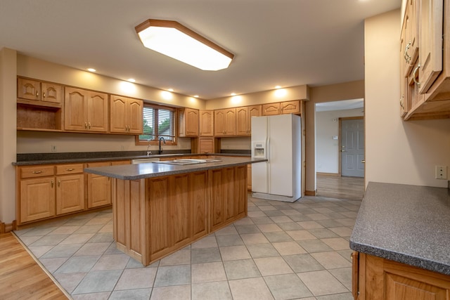 1820 N Hemlock Ridge Rd, Rocheport, MO 65279 - kitchen featuring white refrigerator with ice dispenser, a sink, dark countertops, a center island, and recessed lighting