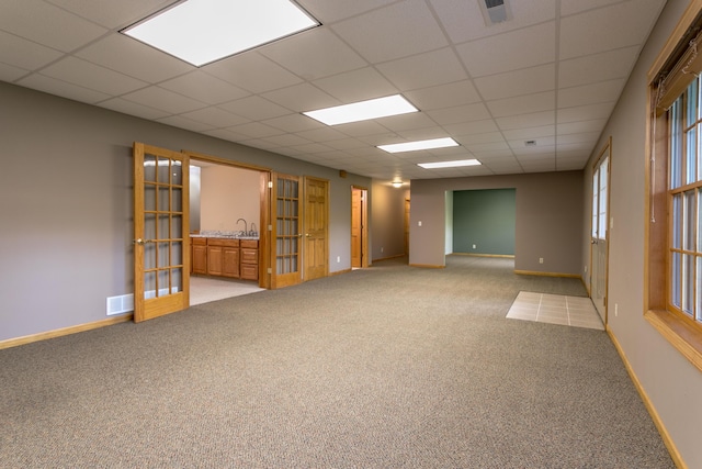 1820 N Hemlock Ridge Rd, Rocheport, MO 65279 - empty room with light carpet, a drop ceiling, baseboards, and a sink