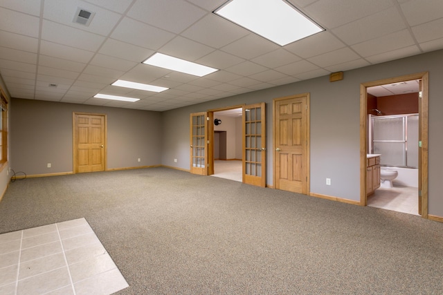 1820 N Hemlock Ridge Rd, Rocheport, MO 65279 - empty room with carpet, baseboards, a drop ceiling, and french doors
