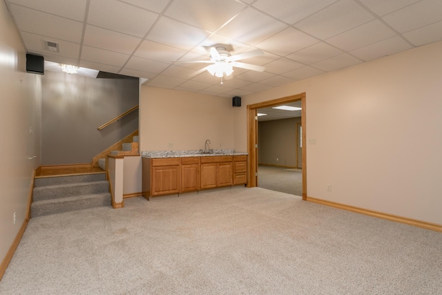 1820 N Hemlock Ridge Rd, Rocheport, MO 65279 - finished below grade area featuring light carpet, a paneled ceiling, bar with sink, stairs, and baseboards