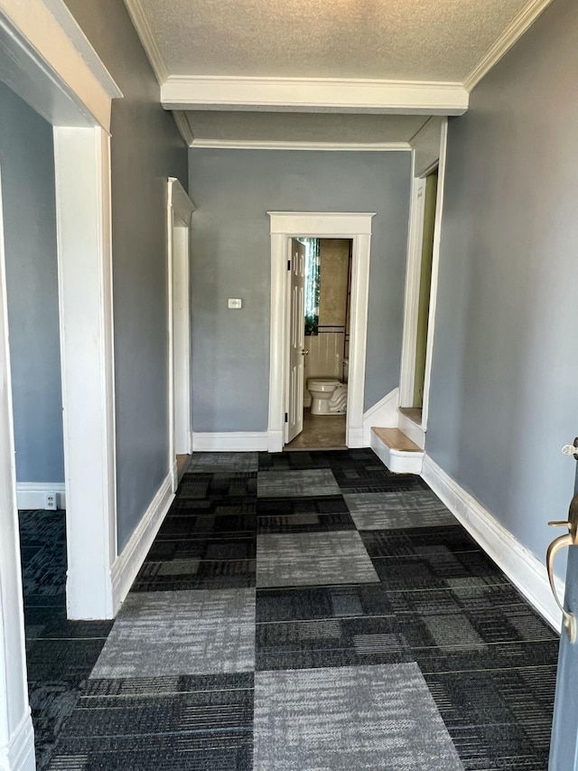 112 W 6th St, Fulton, MO 65251 - hall featuring dark colored carpet, a textured ceiling, ornamental molding, and baseboards