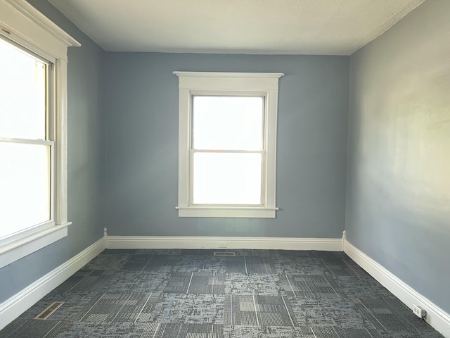 112 W 6th St, Fulton, MO 65251 - spare room featuring dark colored carpet and baseboards