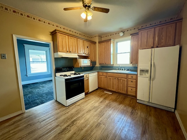 112 W 6th St, Fulton, MO 65251 - kitchen with white appliances, under cabinet range hood, a sink, wood finished floors, and baseboards