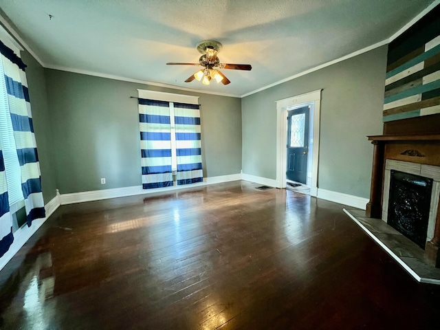112 W 6th St, Fulton, MO 65251 - unfurnished living room featuring ceiling fan, ornamental molding, a fireplace with raised hearth, baseboards, and wood-type flooring