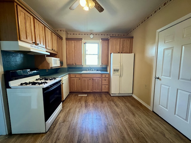 112 W 6th St, Fulton, MO 65251 - kitchen with white appliances, under cabinet range hood, a sink, dark wood-style floors, and ceiling fan