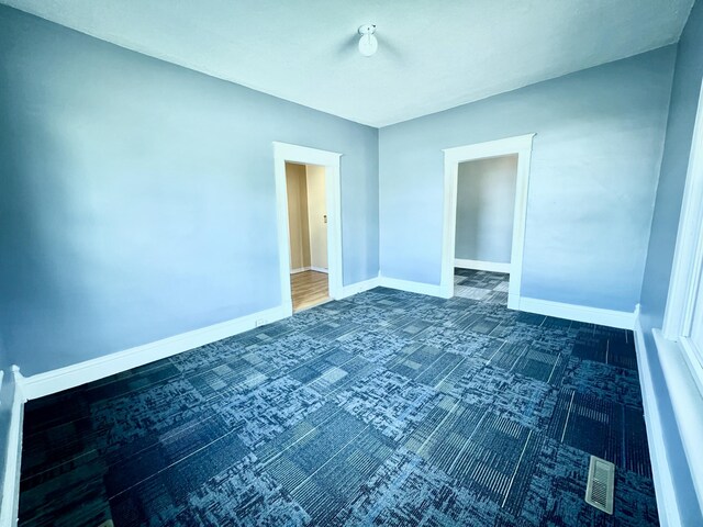 112 W 6th St, Fulton, MO 65251 - empty room featuring dark carpet and baseboards