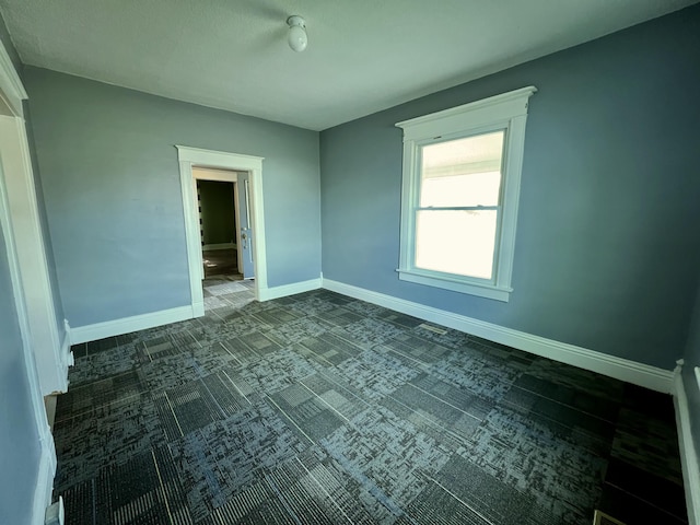 112 W 6th St, Fulton, MO 65251 - spare room featuring baseboards and dark carpet