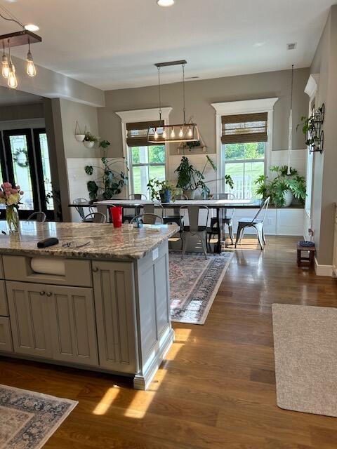 15172 S Henry Ln, Ashland, MO 65010 - kitchen featuring healthy amount of natural light, light stone counters, and dark wood-type flooring
